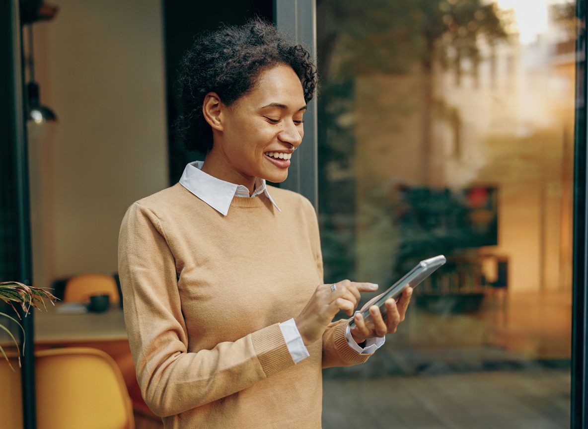 Woman standing at home and use mobile phone for shopping online or enjoy with social media