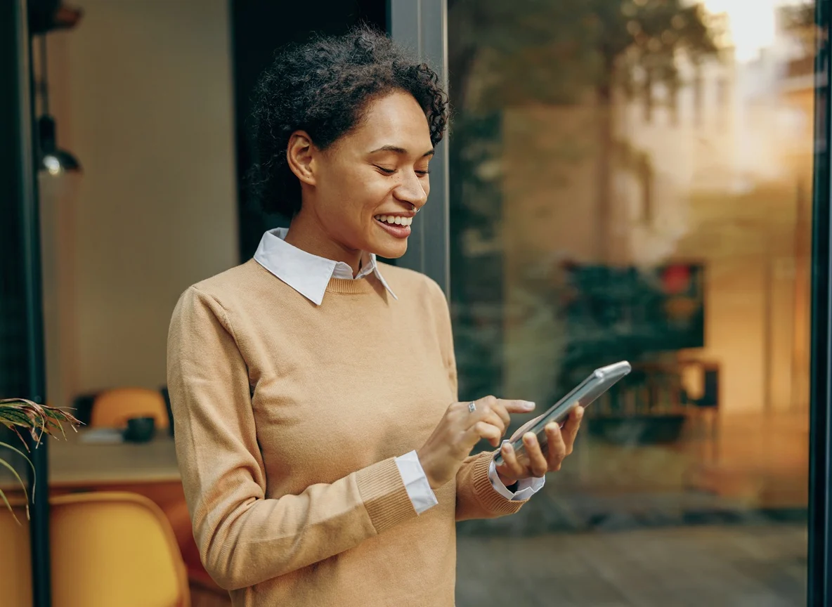 Woman standing at home and use mobile phone for shopping online or enjoy with social media